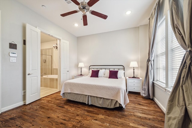 bedroom with dark wood-type flooring, ceiling fan, and connected bathroom