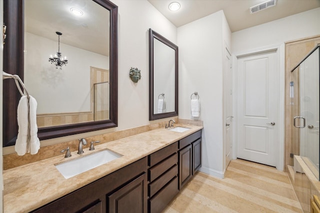 bathroom featuring an inviting chandelier, walk in shower, and vanity