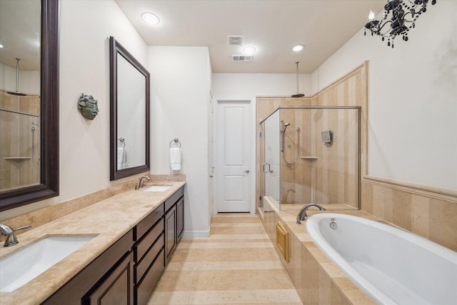 bathroom with vanity and independent shower and bath