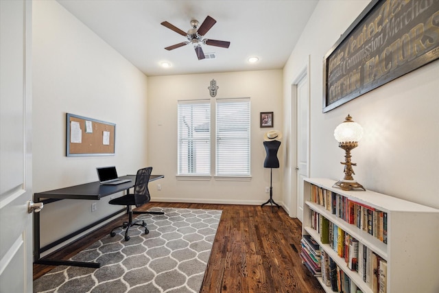 home office with ceiling fan and dark hardwood / wood-style flooring