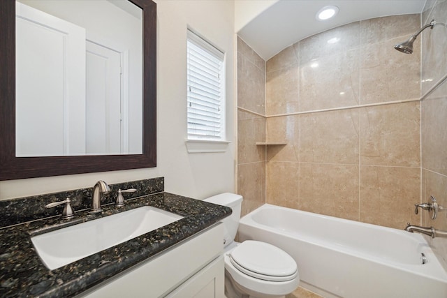 full bathroom featuring toilet, vanity, and tiled shower / bath combo