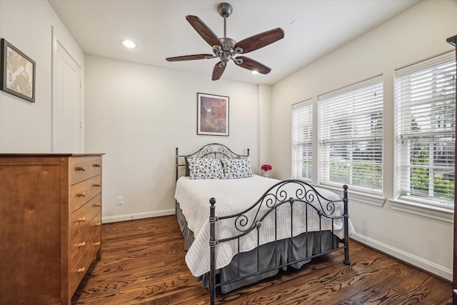 bedroom with ceiling fan and dark hardwood / wood-style floors