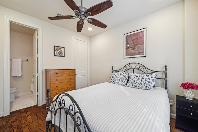 bedroom featuring dark wood-type flooring, ceiling fan, and ensuite bathroom