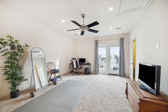 exercise area featuring ceiling fan and light colored carpet