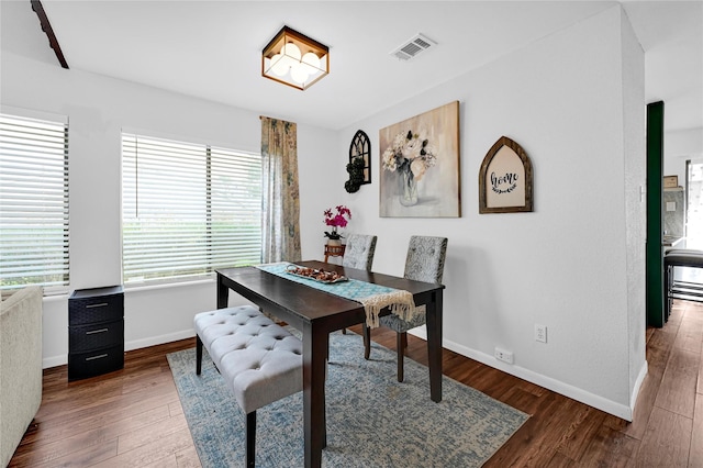 dining area with dark hardwood / wood-style flooring