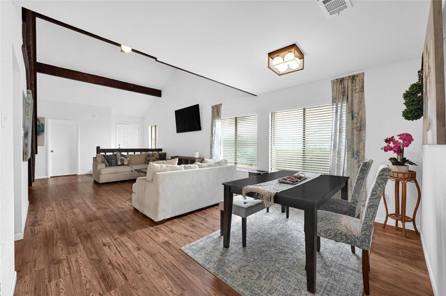 dining space with hardwood / wood-style floors and high vaulted ceiling