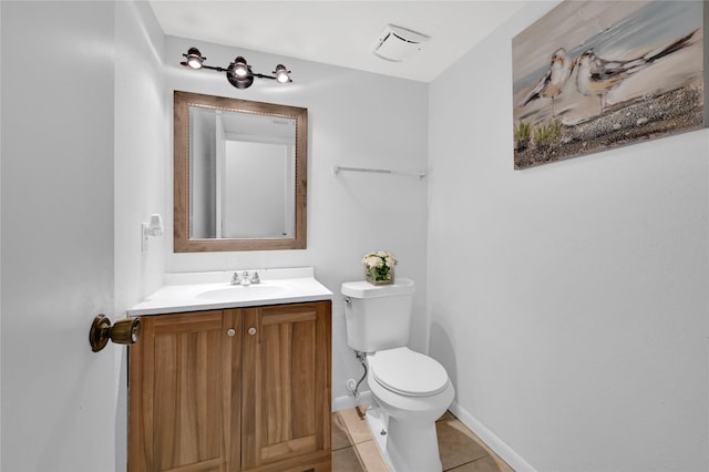 bathroom with tile patterned floors, vanity, and toilet