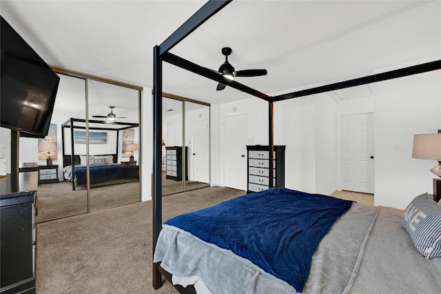 bedroom with multiple closets, light colored carpet, and ceiling fan