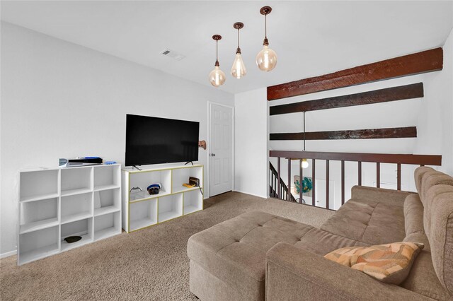 carpeted living room featuring beam ceiling