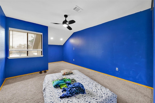 carpeted bedroom with vaulted ceiling and ceiling fan