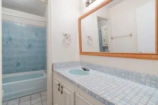 bathroom featuring tile patterned floors, vanity, and shower / bathtub combination