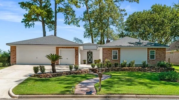 ranch-style home featuring a garage and a front yard