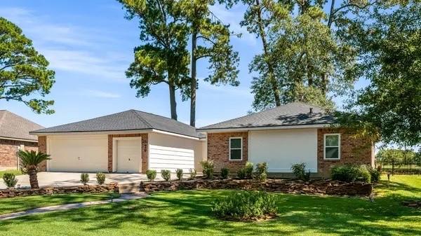 ranch-style home featuring a garage and a front lawn