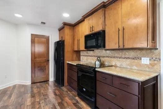 kitchen featuring decorative backsplash, dark hardwood / wood-style floors, and black appliances