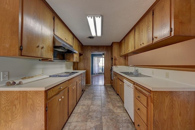 kitchen featuring white dishwasher, stainless steel gas stovetop, oven, and sink