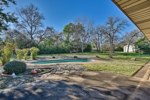 view of pool with a lawn and a patio