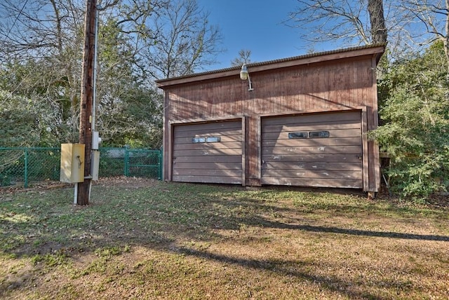 view of outbuilding with a yard and a garage