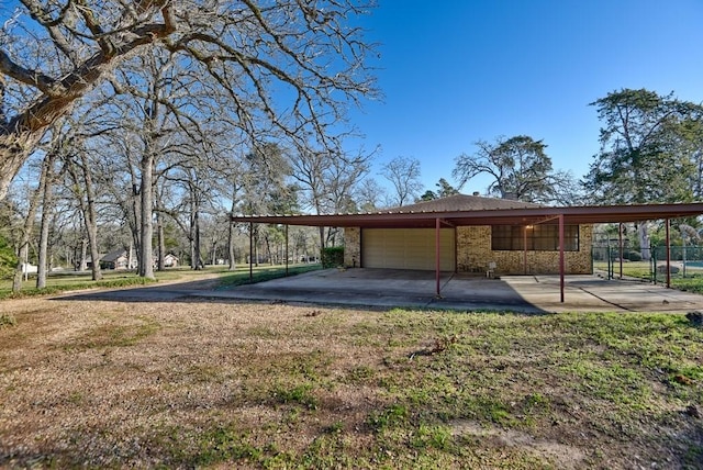 exterior space featuring a carport and a lawn