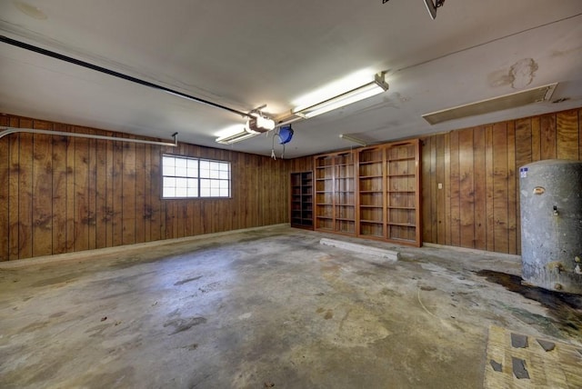 garage with wooden walls and water heater