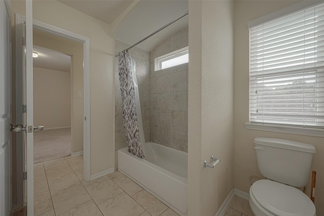 bathroom featuring tile patterned flooring, shower / bath combo, and toilet