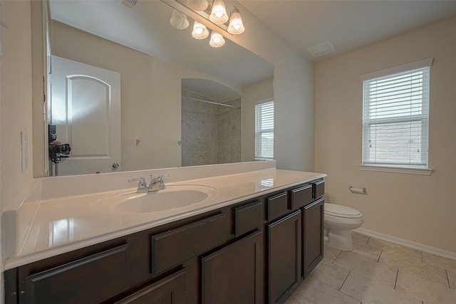 bathroom with tile patterned flooring, vanity, and toilet