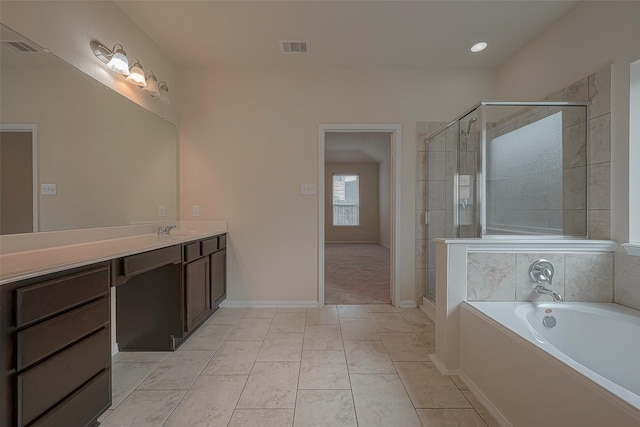 bathroom featuring tile patterned flooring, vanity, and independent shower and bath