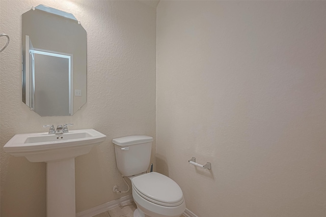 bathroom featuring toilet and sink