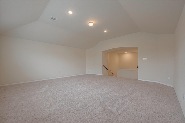 carpeted spare room with lofted ceiling