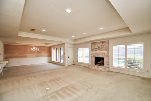 unfurnished living room featuring light carpet, a brick fireplace, and a raised ceiling