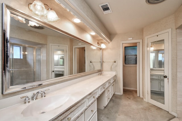 bathroom featuring vanity and a shower with door