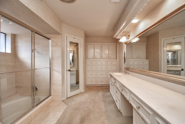 bathroom featuring vanity and bath / shower combo with glass door