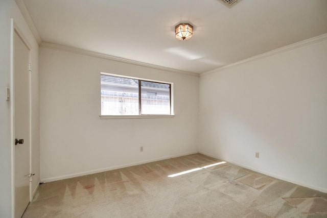 spare room featuring light colored carpet and crown molding