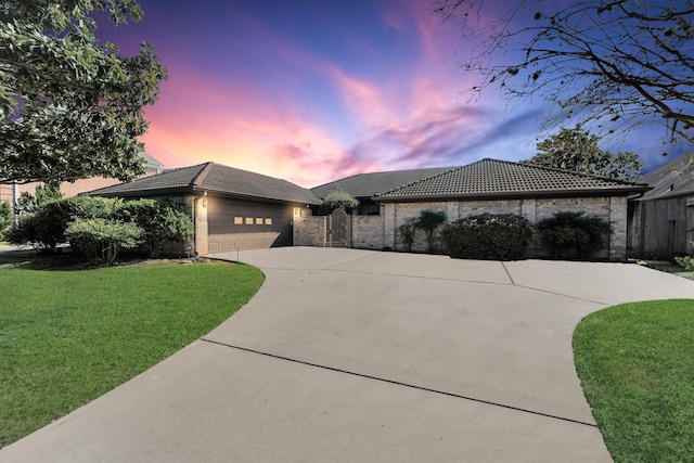 view of front of house with a lawn and a garage