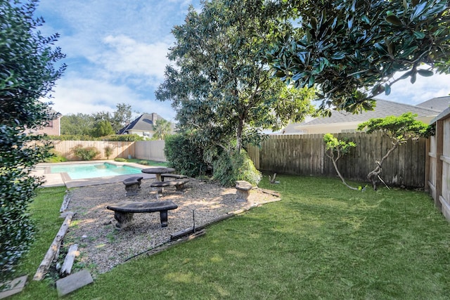 view of yard with a fenced in pool