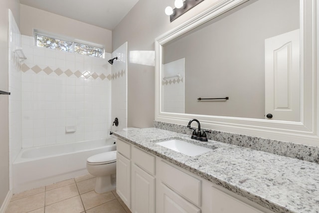 full bathroom featuring toilet, tiled shower / bath combo, tile patterned floors, and vanity