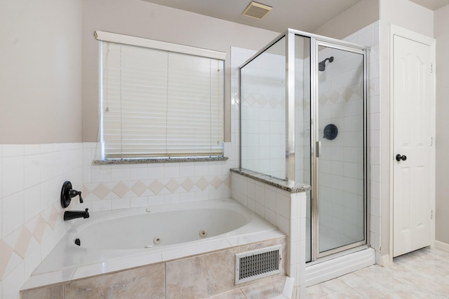 bathroom featuring shower with separate bathtub