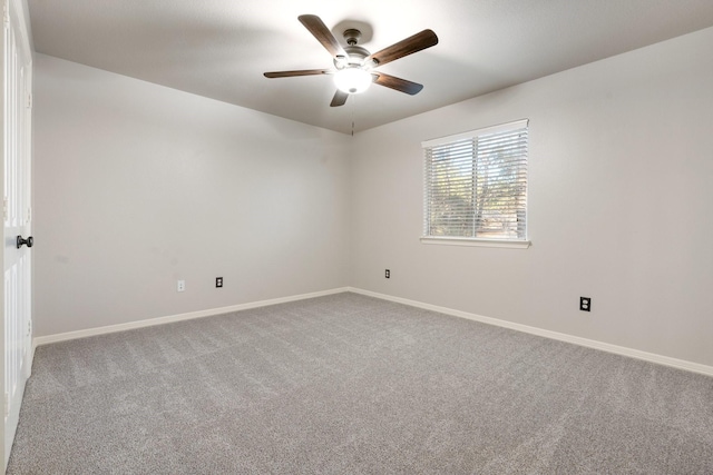 carpeted empty room featuring ceiling fan