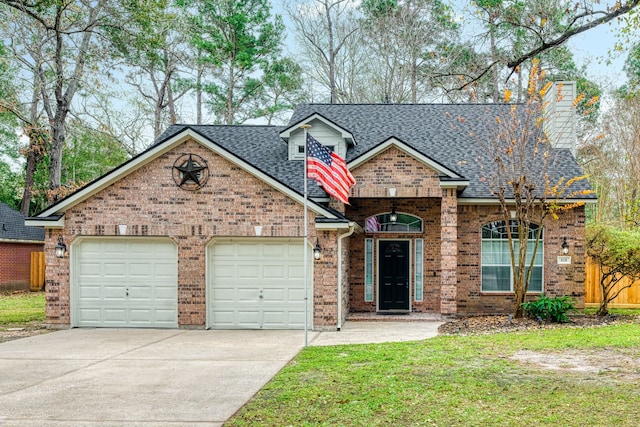 view of front of home with a front yard and a garage