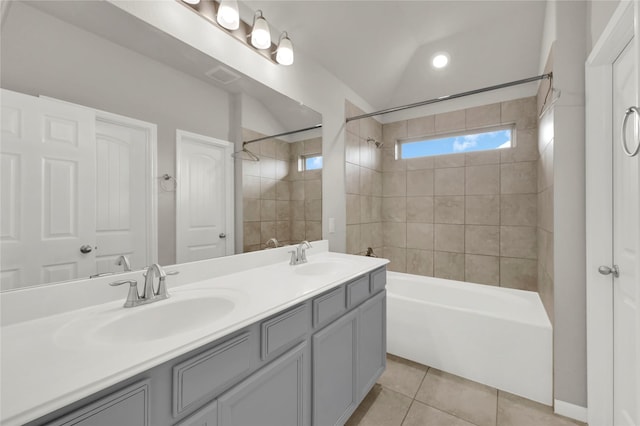 bathroom with tile patterned flooring, vanity, and tiled shower / bath