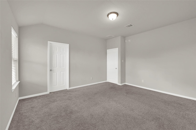 carpeted empty room featuring lofted ceiling and a healthy amount of sunlight