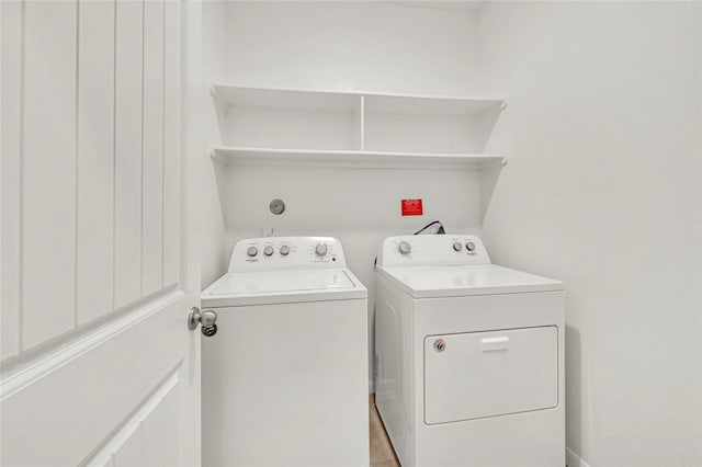 clothes washing area with washer and clothes dryer