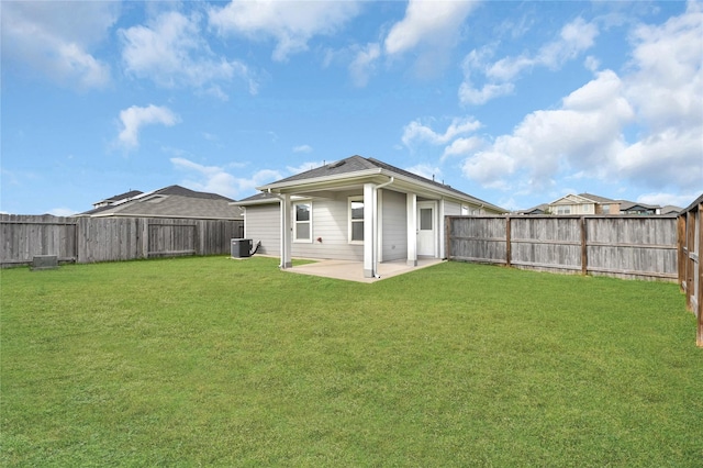 back of house featuring a lawn, cooling unit, and a patio