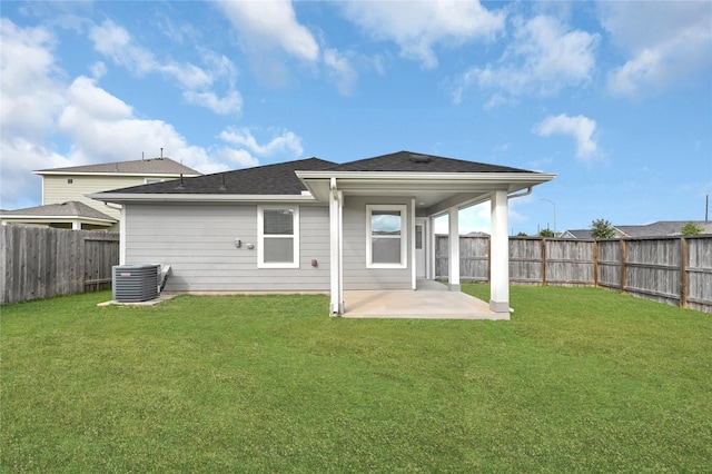 rear view of house featuring a yard, a patio area, and central air condition unit