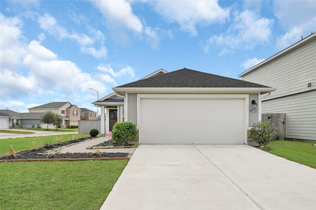 view of front of home featuring a front lawn and a garage