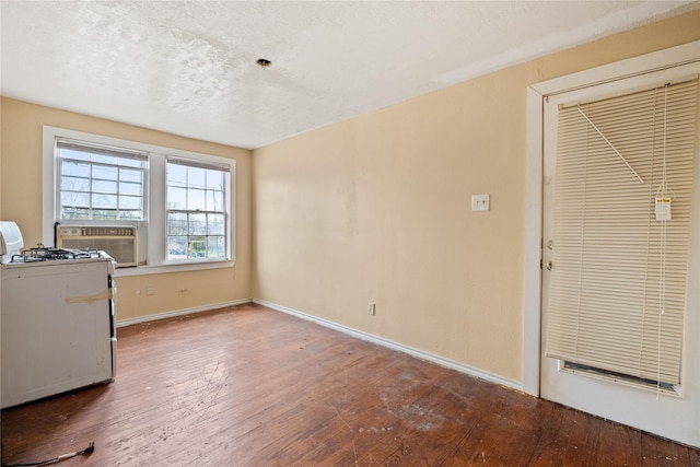 interior space featuring cooling unit, a textured ceiling, and hardwood / wood-style flooring