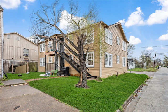 view of side of home with a yard