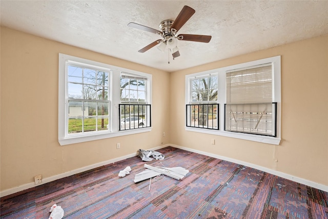 spare room with a textured ceiling and ceiling fan