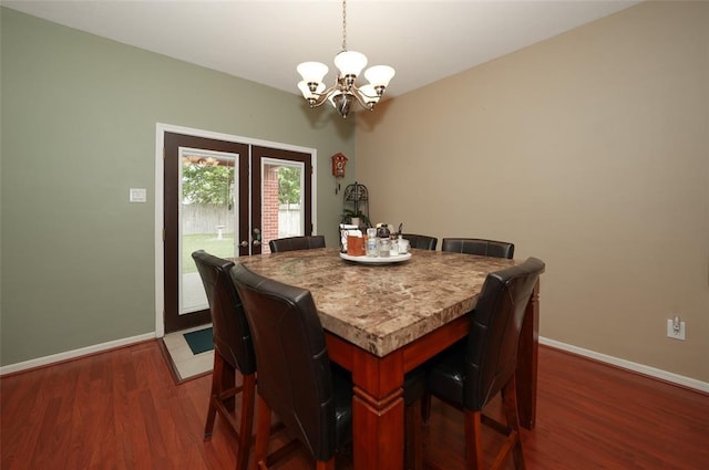 dining area featuring hardwood / wood-style floors, an inviting chandelier, and french doors