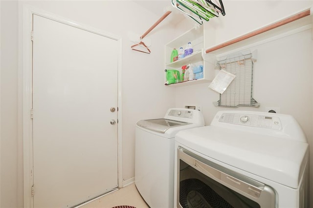 laundry room with washing machine and clothes dryer