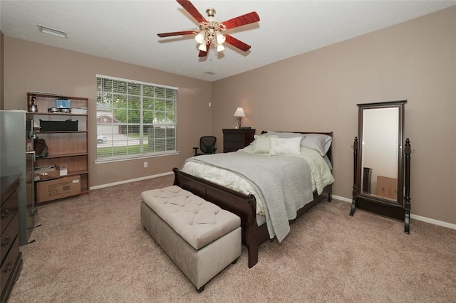 bedroom with light colored carpet and ceiling fan